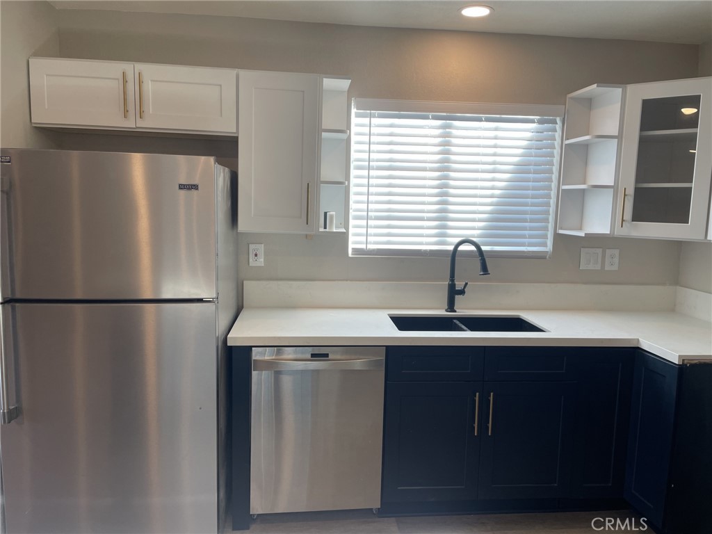 820 North Lassen Street Willows, CA 95988 - Photo 7 of 18 a kitchen with a sink a refrigerator and window