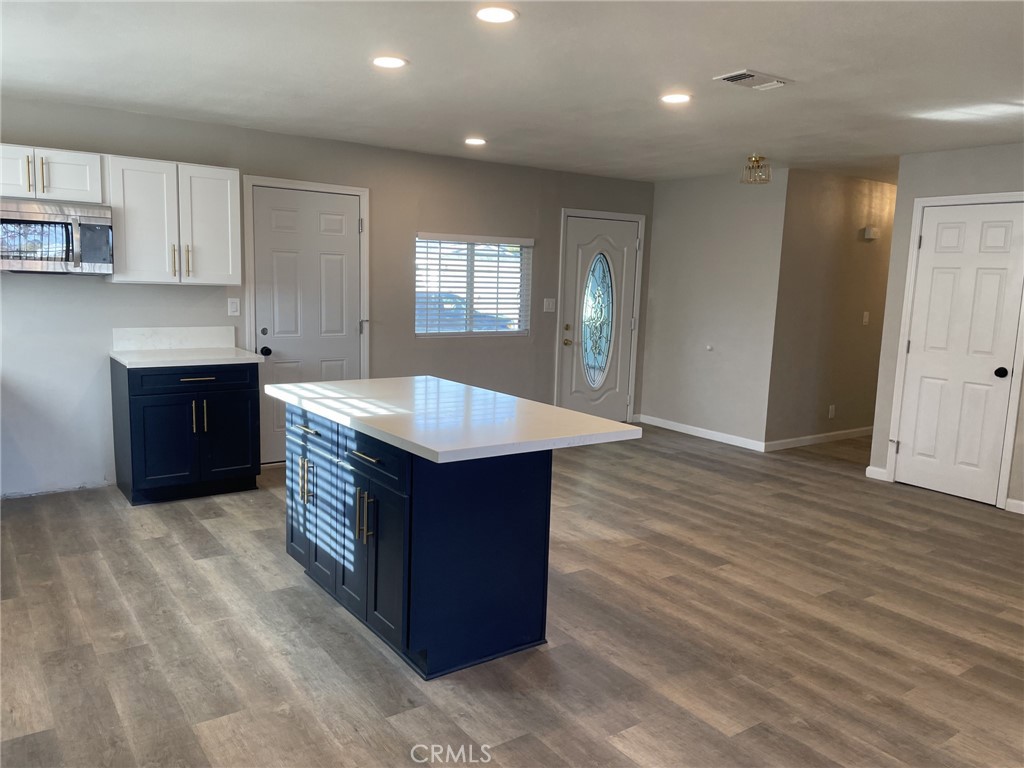820 North Lassen Street Willows, CA 95988 - Photo 8 of 18 a kitchen with stainless steel appliances granite countertop a kitchen island a hardwood floor and a sink
