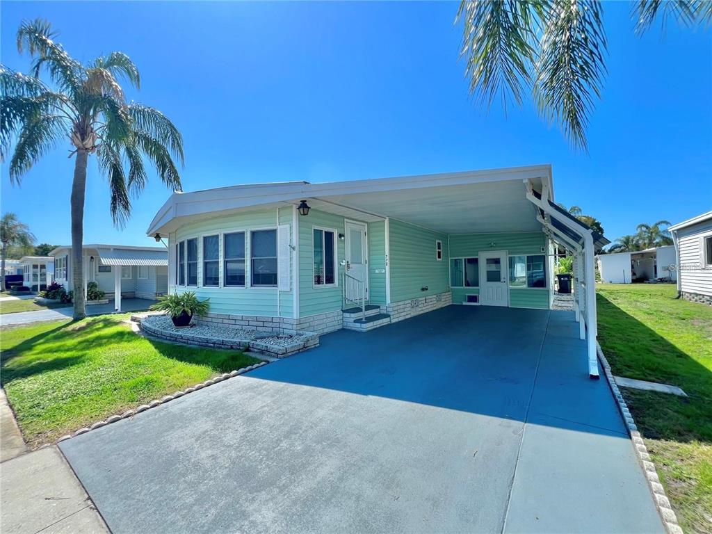 1100 South Belcher Road, Unit 772 Largo, FL 33771 - Photo 1 of 84 a view of a house with a yard and potted plants