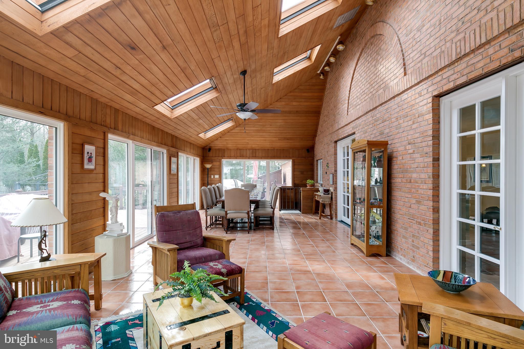 2 Teaberry Drive Medford, NJ 08055 - Photo 13 of 43 a view of a patio with table and chairs potted plants and floor to ceiling window