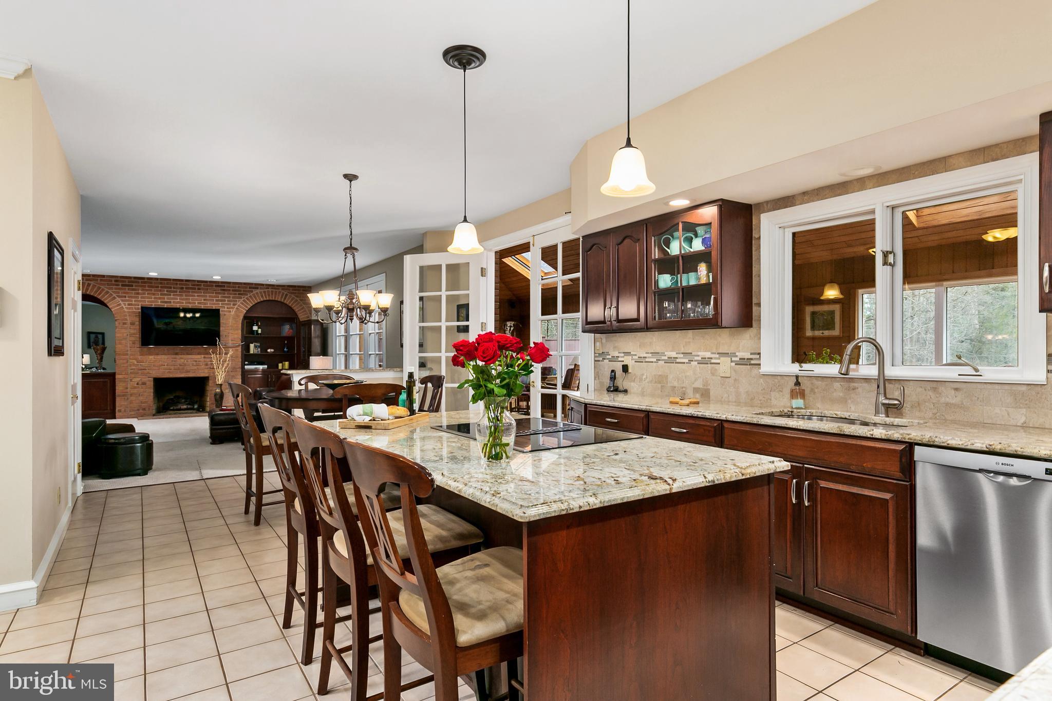 2 Teaberry Drive Medford, NJ 08055 - Photo 9 of 43 a open kitchen with stainless steel appliances granite countertop a stove a sink dishwasher a dining table and chairs with wooden floor