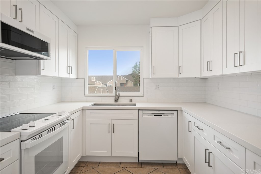 34026 Selva Road, Unit 65 Dana Point, CA 92629 - Photo 9 of 22 a kitchen with cabinets appliances a sink and a window