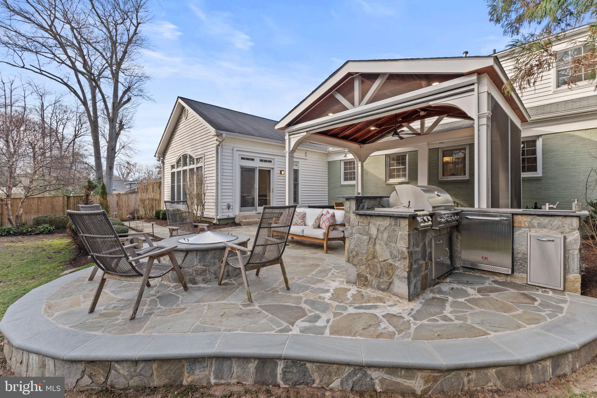 2407 Culpeper Road Alexandria, VA 22308 - Photo 50 of 57 A gas fire pit next to outdoor kitchen.