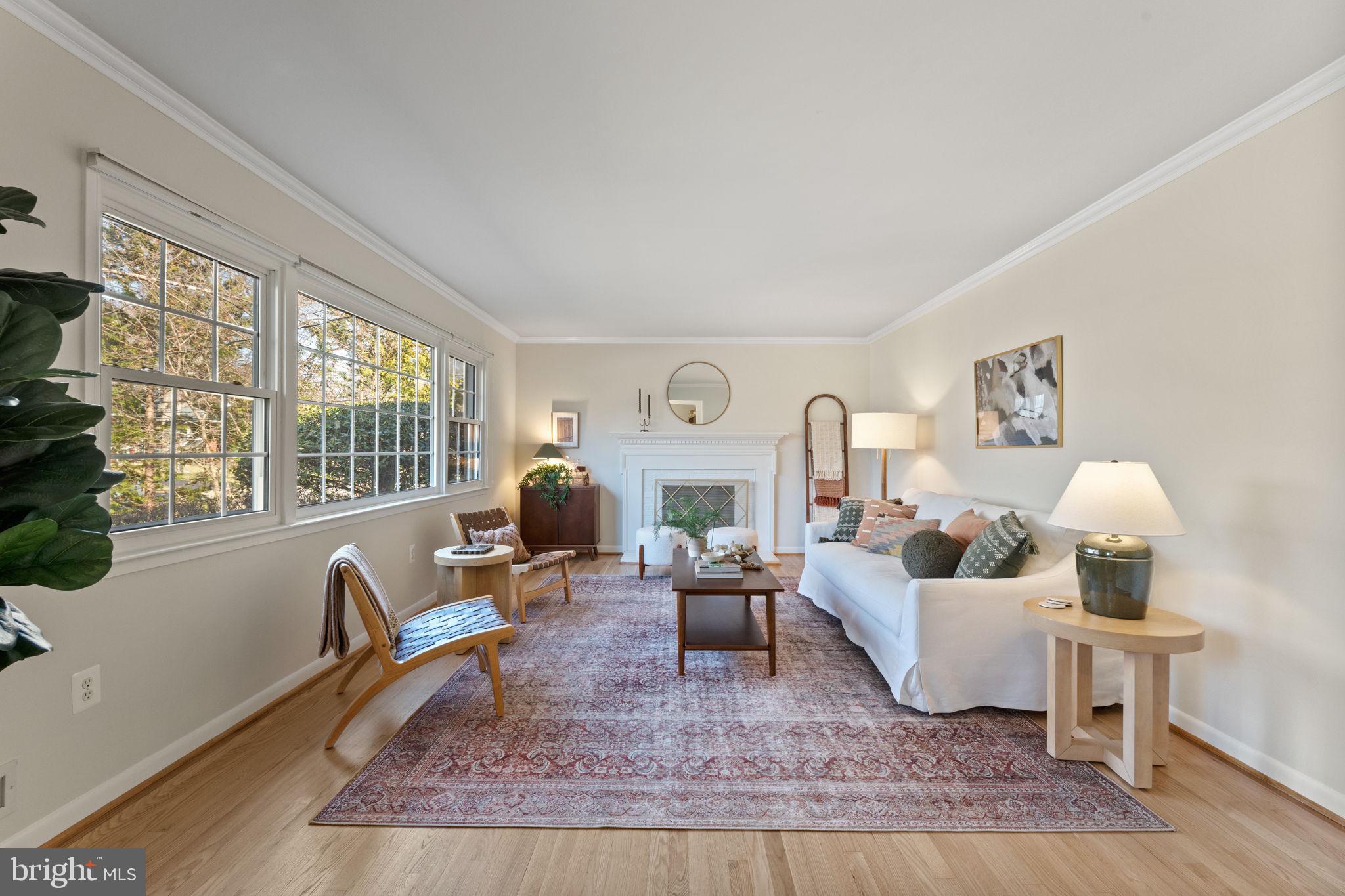 A bright living room w/ wood burning fireplace.