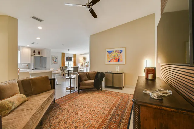 a dining hall with stainless steel appliances kitchen island granite countertop a table and chairs