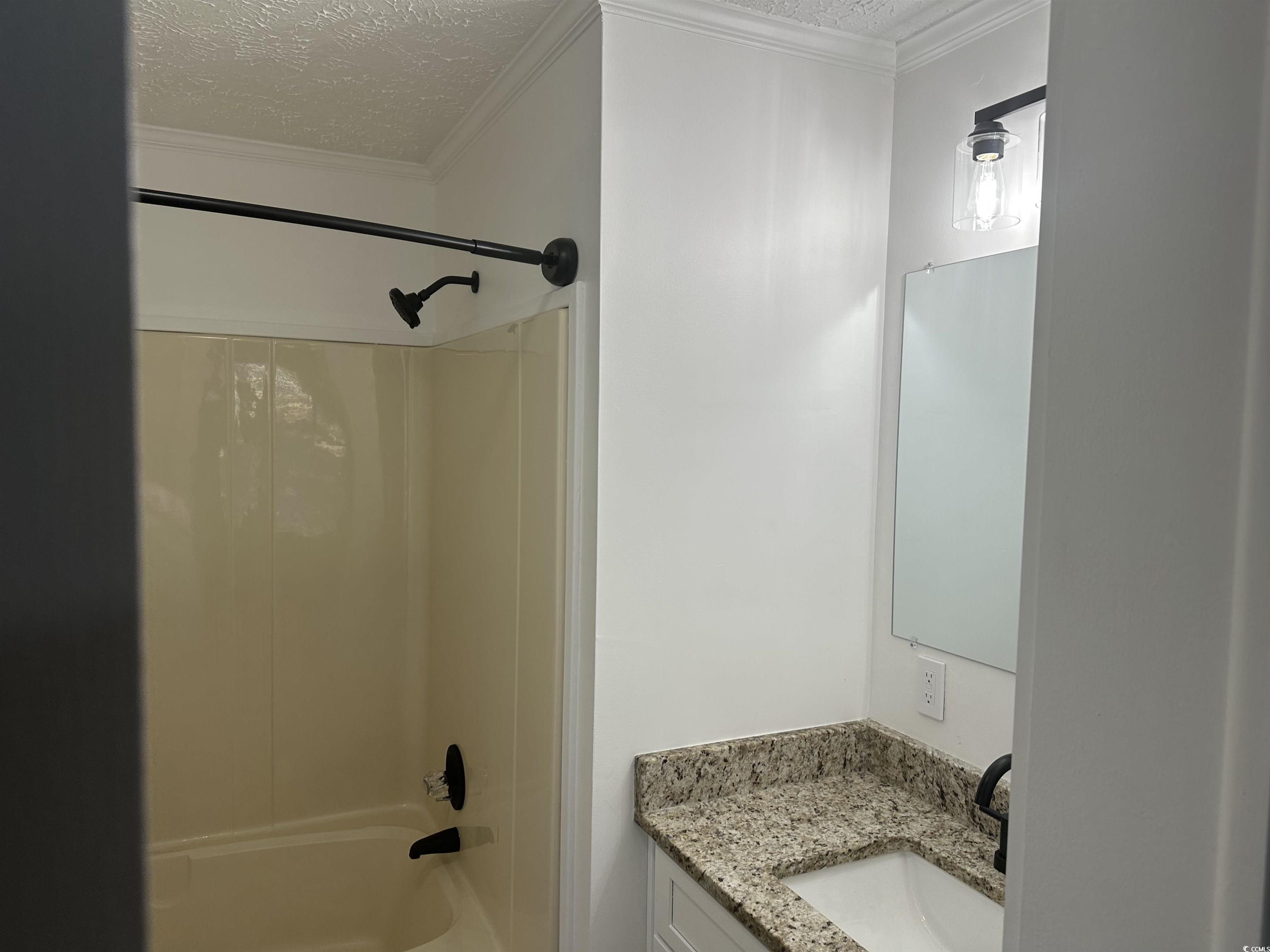 3800 Murrells Inlet Road Murrells Inlet, SC 29576 - Photo 14 of 22 Bathroom with a textured ceiling, shower / tub combo, vanity, and ornamental molding