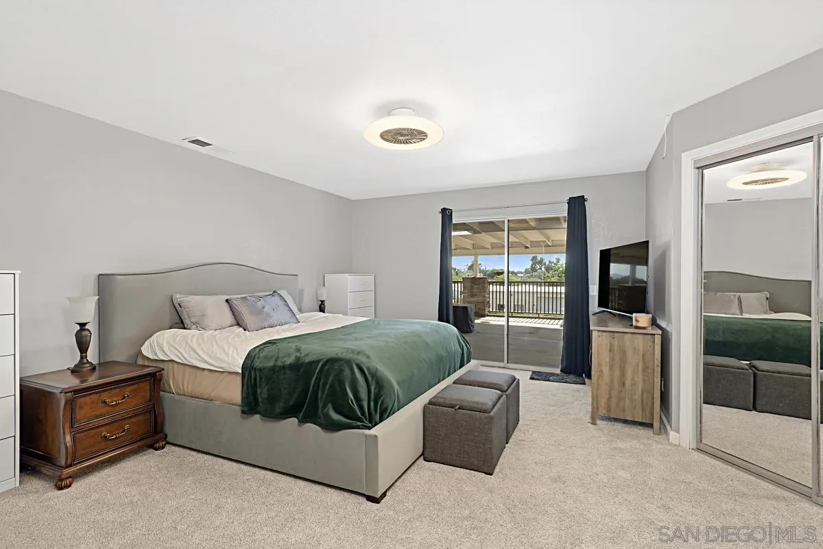 821 Steffy Road Ramona, CA 92065 - Photo 19 of 35 a spacious bedroom with a bed and a walk in closet