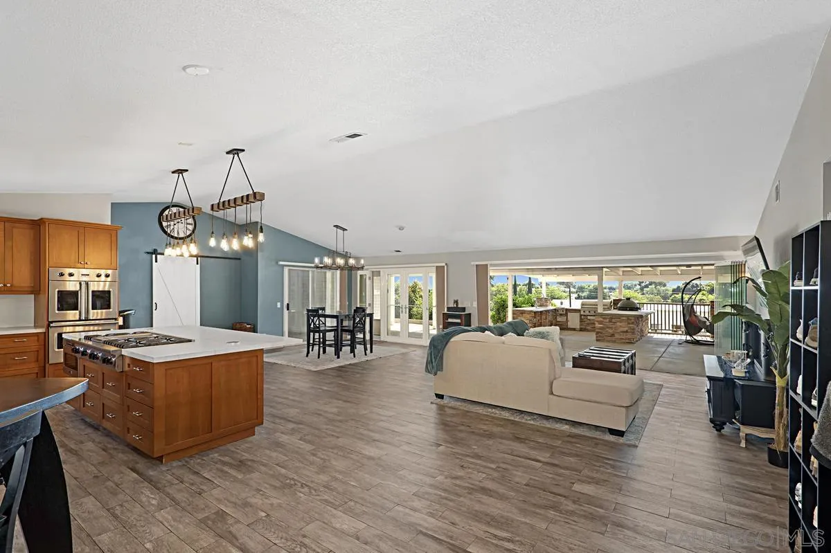 821 Steffy Road Ramona, CA 92065 - Photo 4 of 35 a living room with furniture dining table a large window and a chandelier