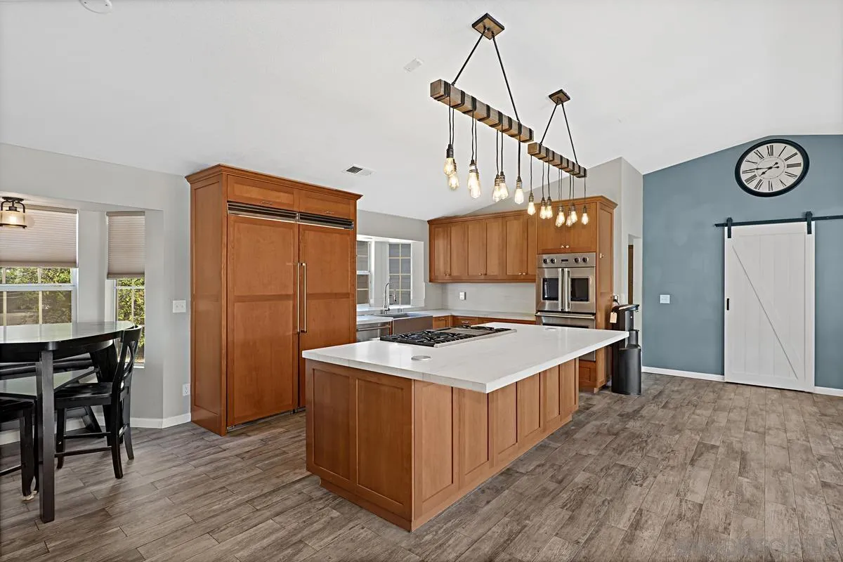 821 Steffy Road Ramona, CA 92065 - Photo 5 of 35 a kitchen that has a sink a stove a table and chairs in it