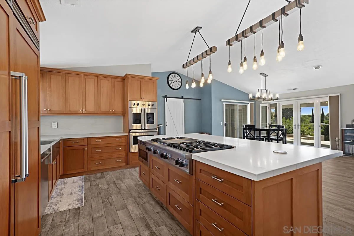 821 Steffy Road Ramona, CA 92065 - Photo 6 of 35 a kitchen with stainless steel appliances granite countertop a stove and a refrigerator