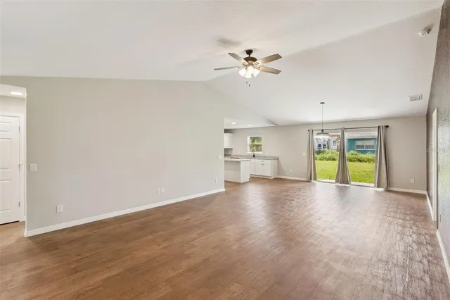 a view of a livingroom with a ceiling fan and window