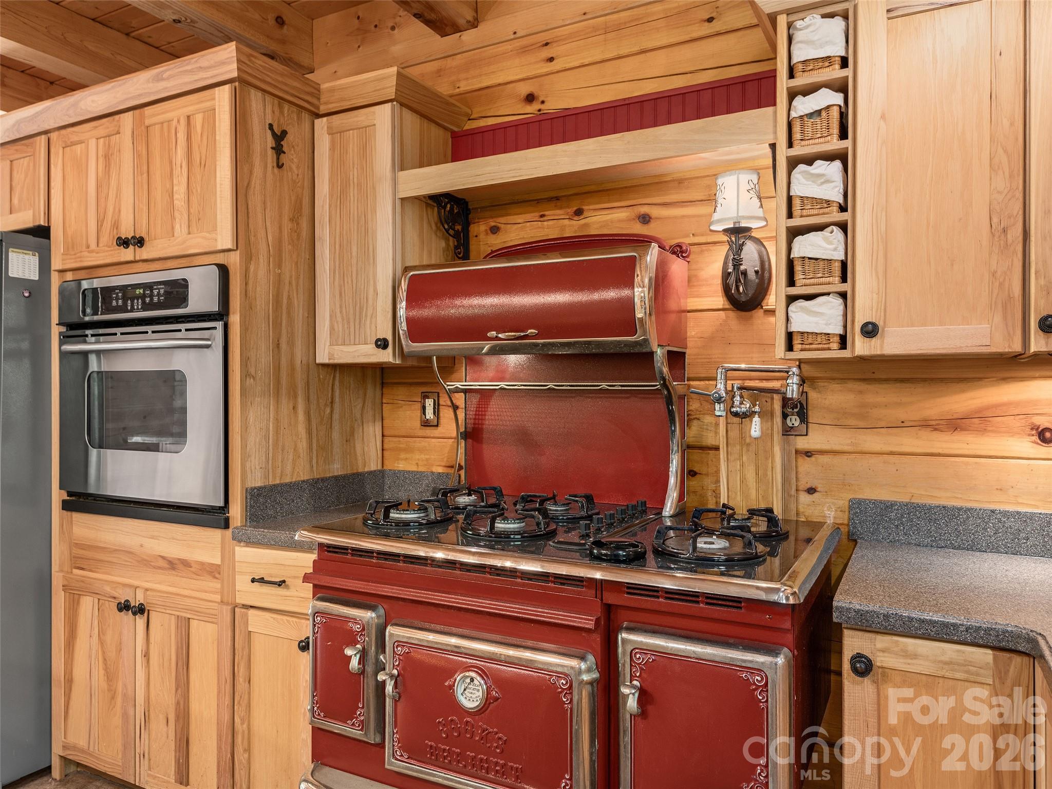 413 Green Hills Road Mill Spring, NC 28756 - Photo 13 of 48 a kitchen with stainless steel appliances granite countertop a stove and a microwave