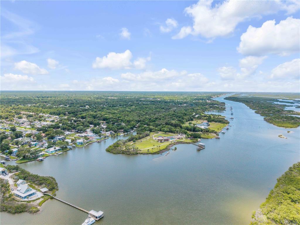 192 Azalea Road Edgewater, FL 32141 - Photo 72 of 94 an aerial view of a city with lots of residential buildings ocean and mountain view in back