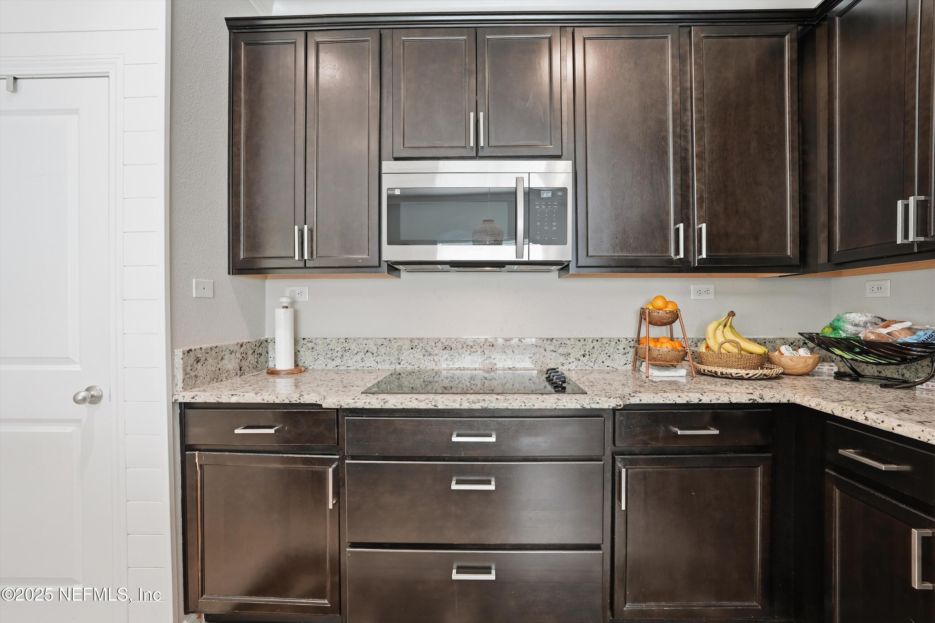3884 Hammock Bluff Drive Jacksonville, FL 32226 - Photo 13 of 34 a kitchen with granite countertop wood cabinets stainless steel appliances and a sink