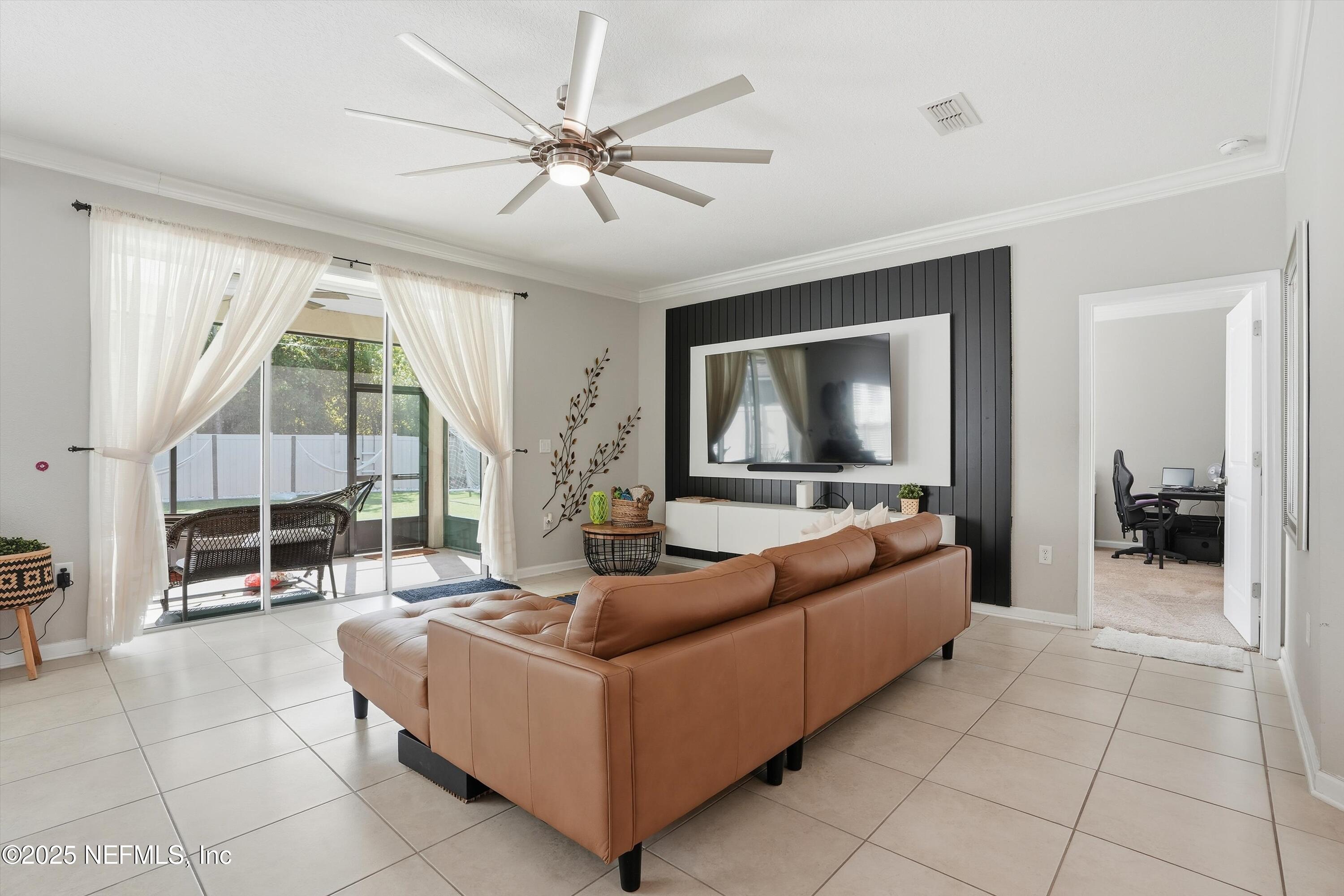 3884 Hammock Bluff Drive Jacksonville, FL 32226 - Photo 17 of 34 a living room with furniture and a flat screen tv