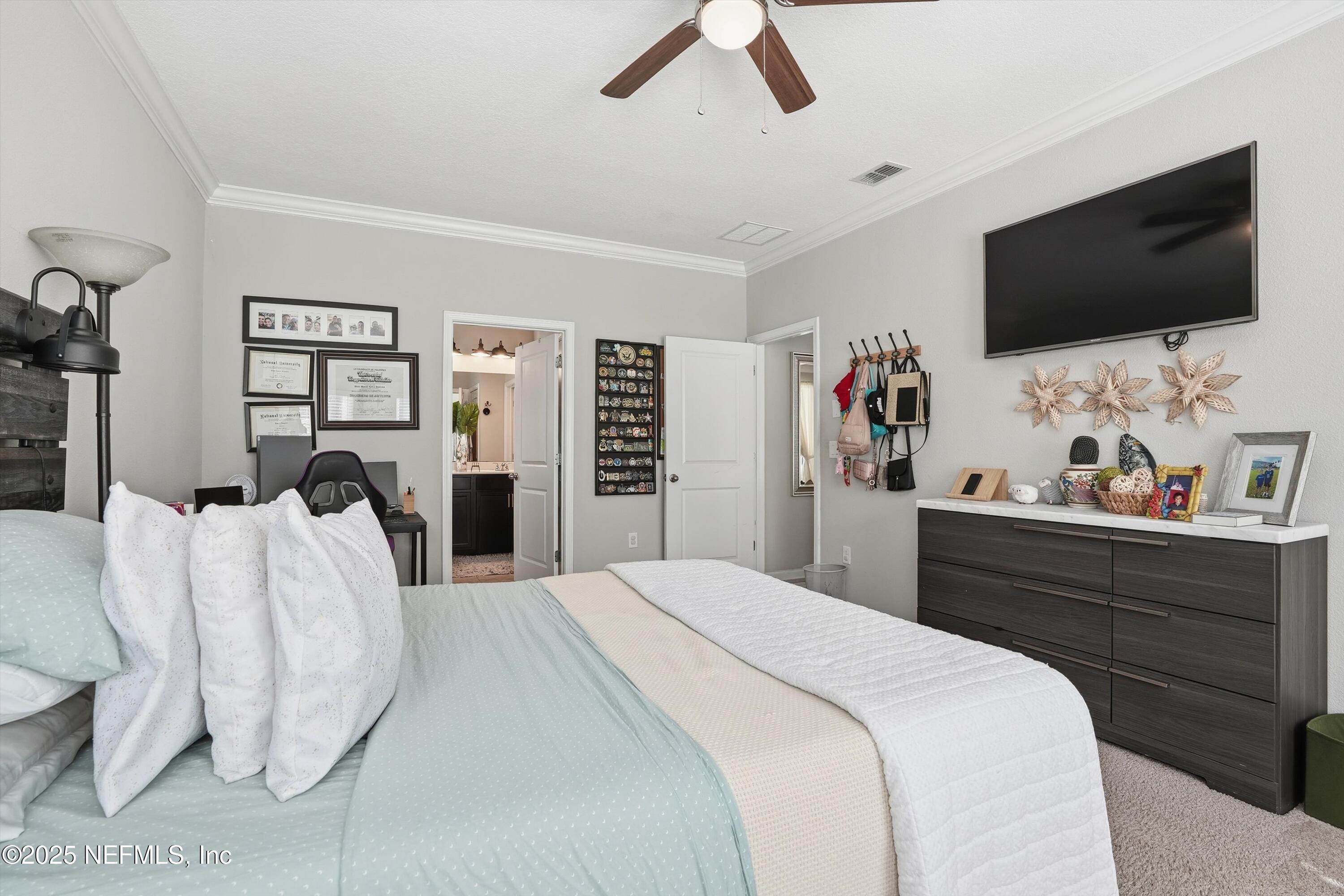 3884 Hammock Bluff Drive Jacksonville, FL 32226 - Photo 20 of 34 a bed room with a bed a television and a large closet