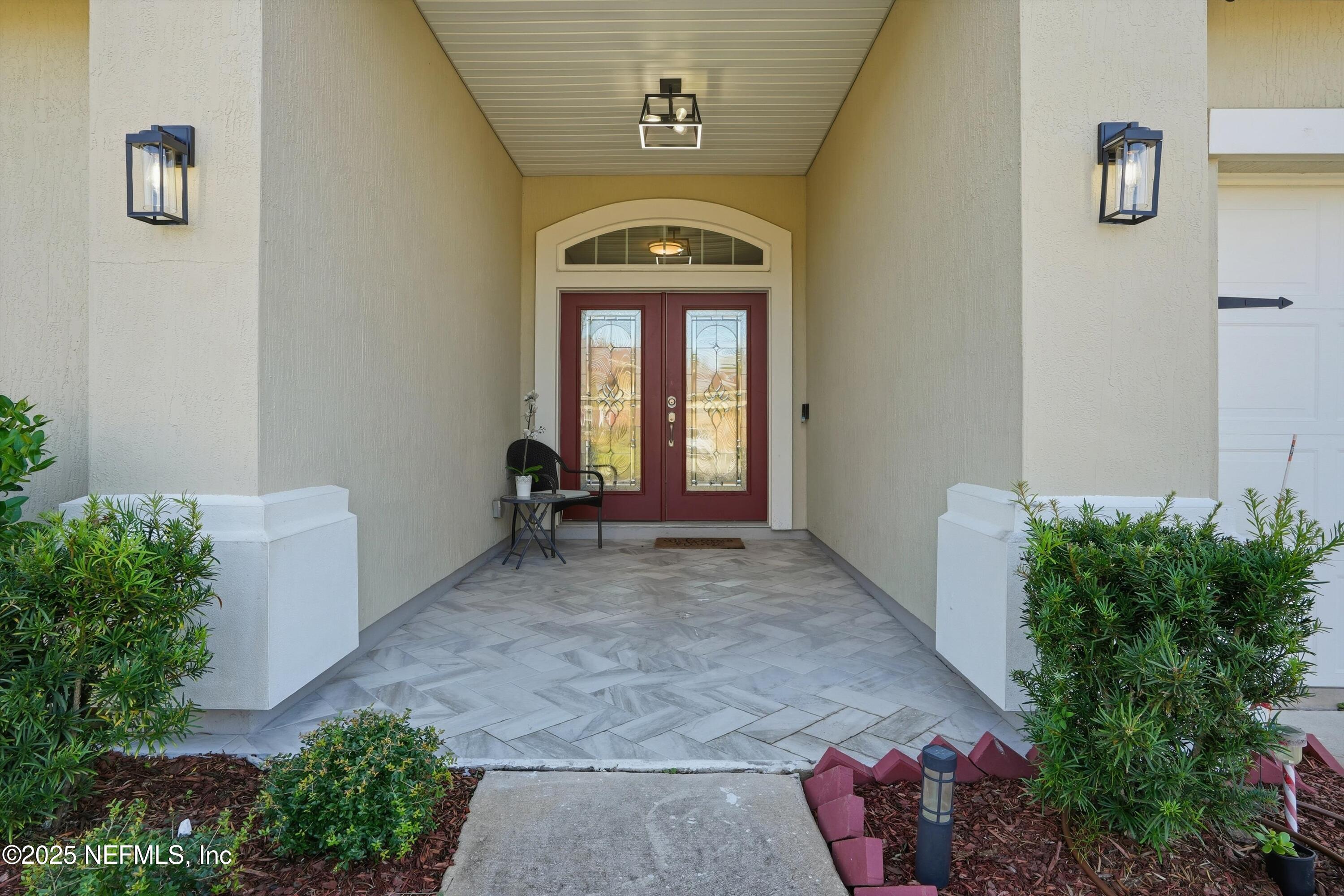 3884 Hammock Bluff Drive Jacksonville, FL 32226 - Photo 2 of 34 a view of a hallway with entryway and flowers
