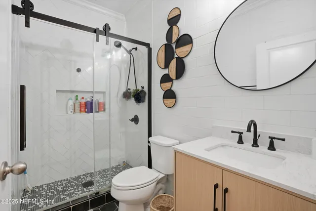 a bathroom with a sink a toilet and a mirror