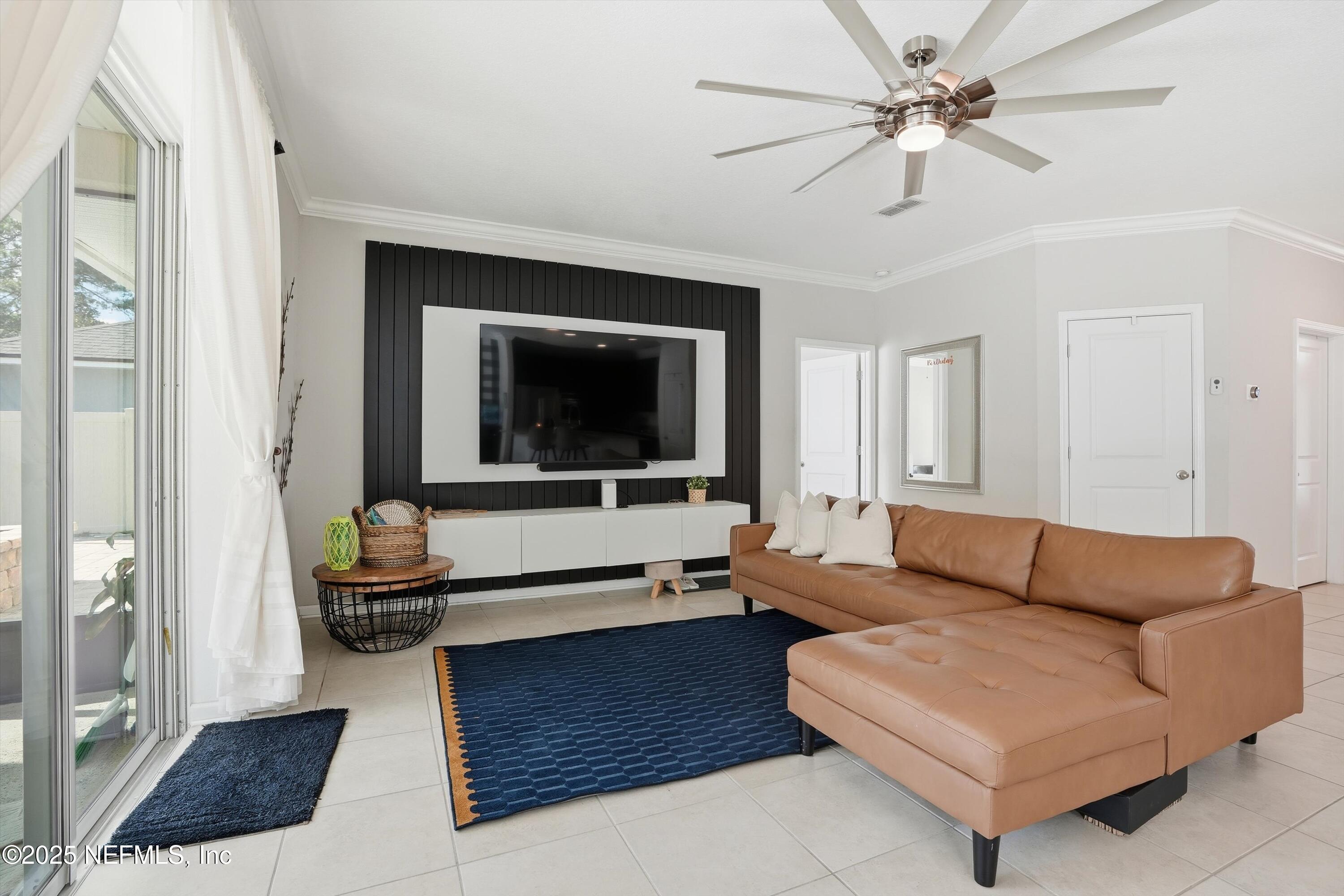 3884 Hammock Bluff Drive Jacksonville, FL 32226 - Photo 4 of 34 a living room with furniture and a flat screen tv