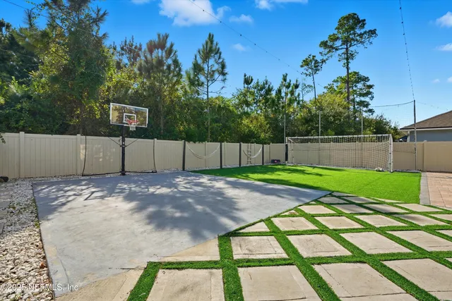 a view of a backyard with wooden fence