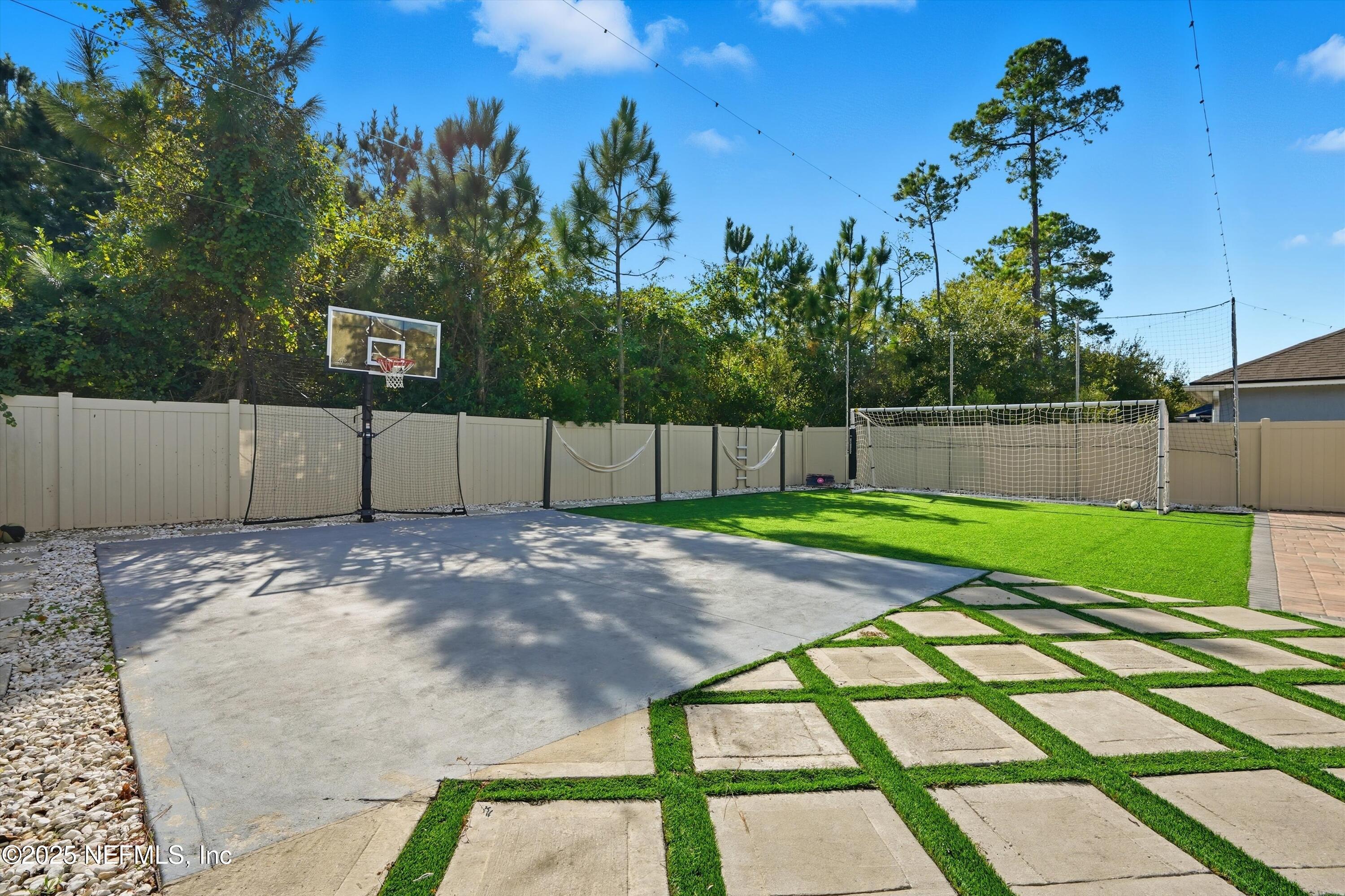 3884 Hammock Bluff Drive Jacksonville, FL 32226 - Photo 5 of 34 a view of a backyard with wooden fence