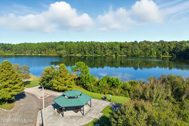 a view of a lake with a house in the background