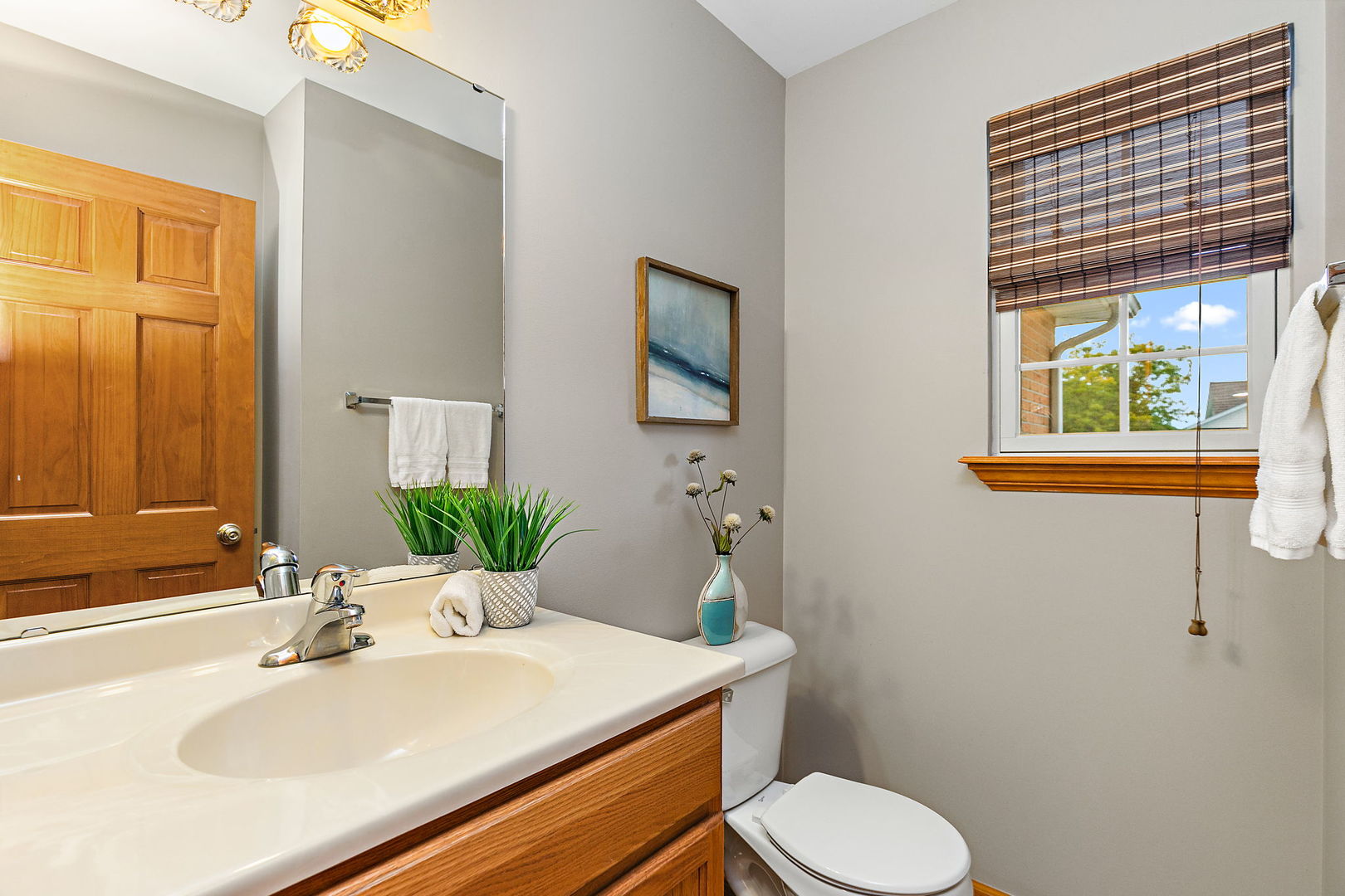 685 Persimmon Street DeKalb, IL 60115 - Photo 15 of 38 a bathroom with a sink toilet and a mirror