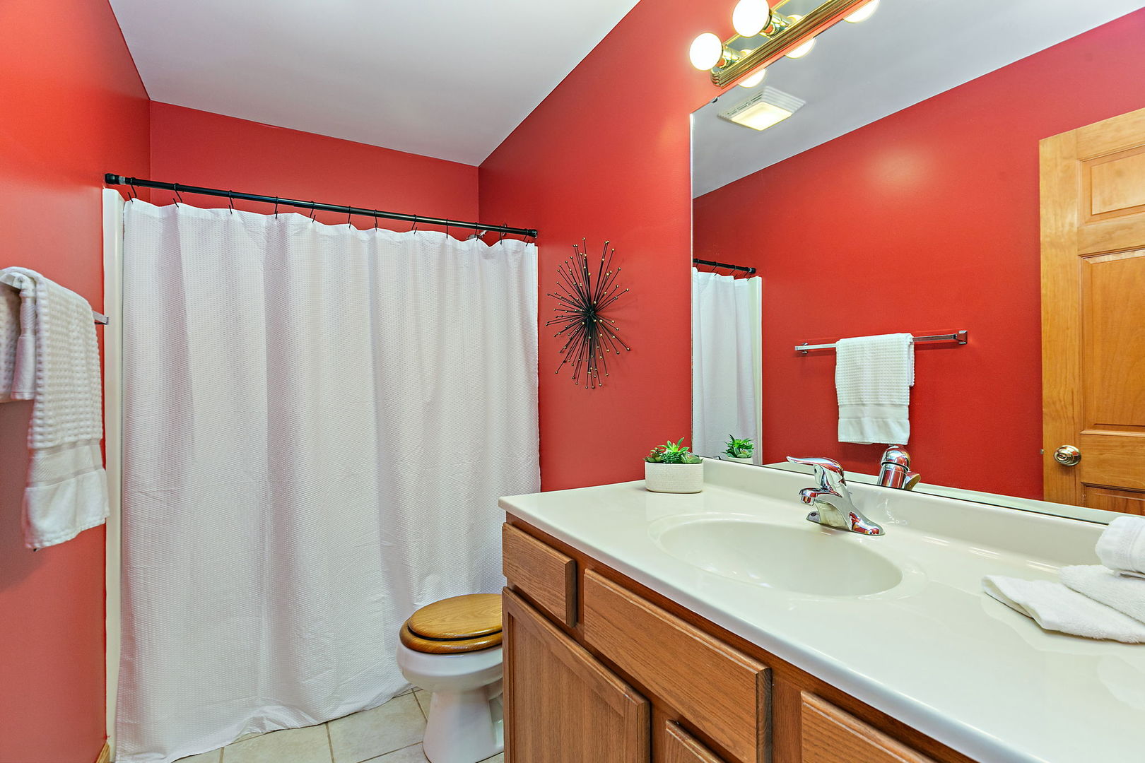 685 Persimmon Street DeKalb, IL 60115 - Photo 17 of 38 a bathroom with a sink a toilet and shower