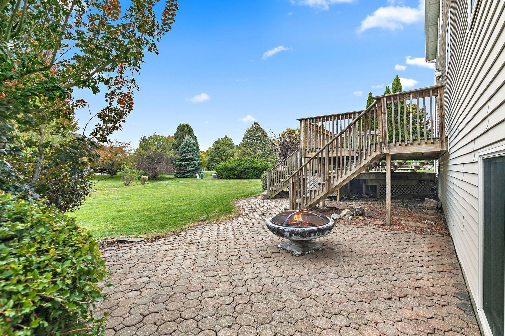 685 Persimmon Street DeKalb, IL 60115 - Photo 29 of 38 a view of a chair and tables in the patio next to a yard
