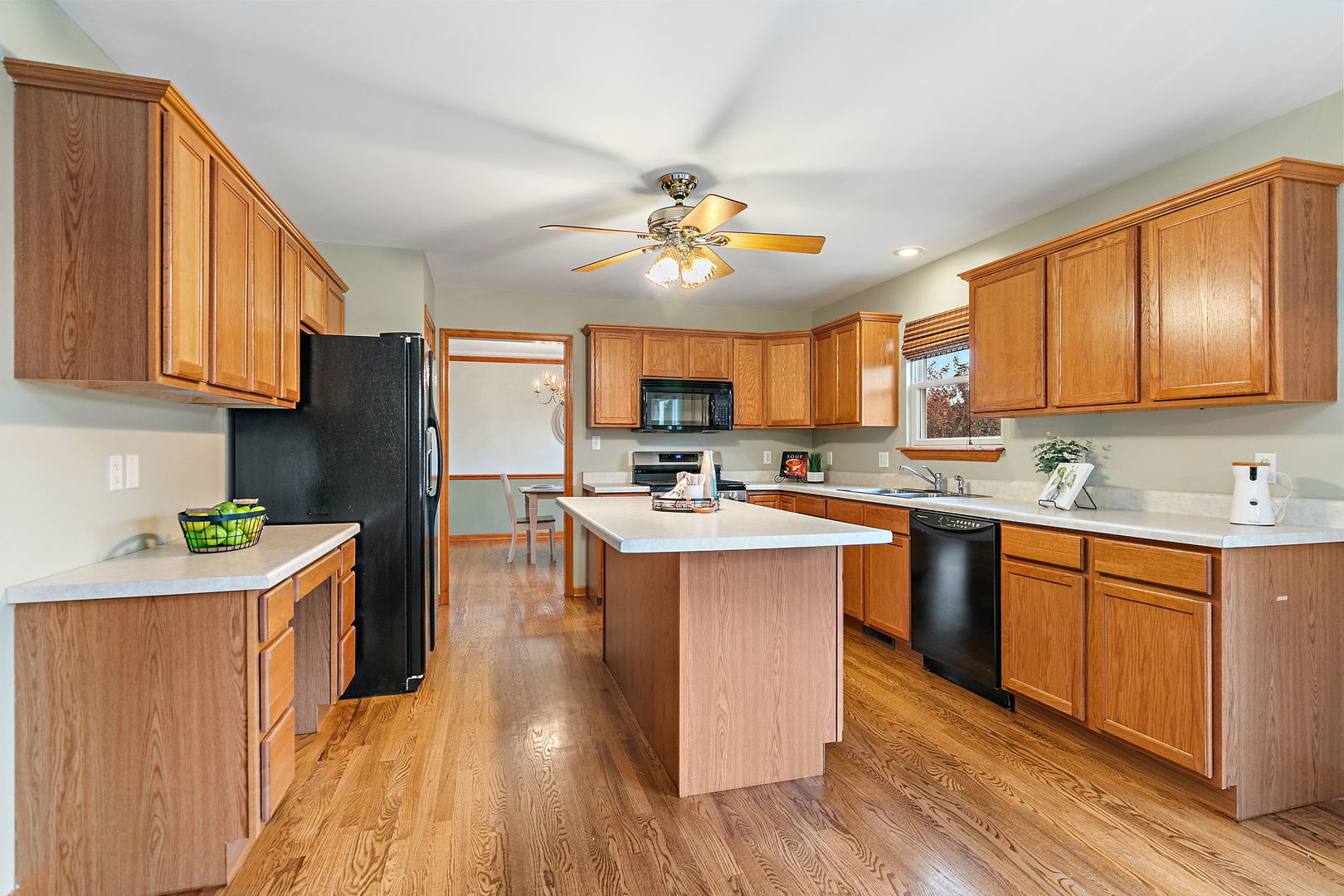 685 Persimmon Street DeKalb, IL 60115 - Photo 9 of 38 a kitchen with stainless steel appliances granite countertop a refrigerator a sink dishwasher a stove with wooden cabinets and floor