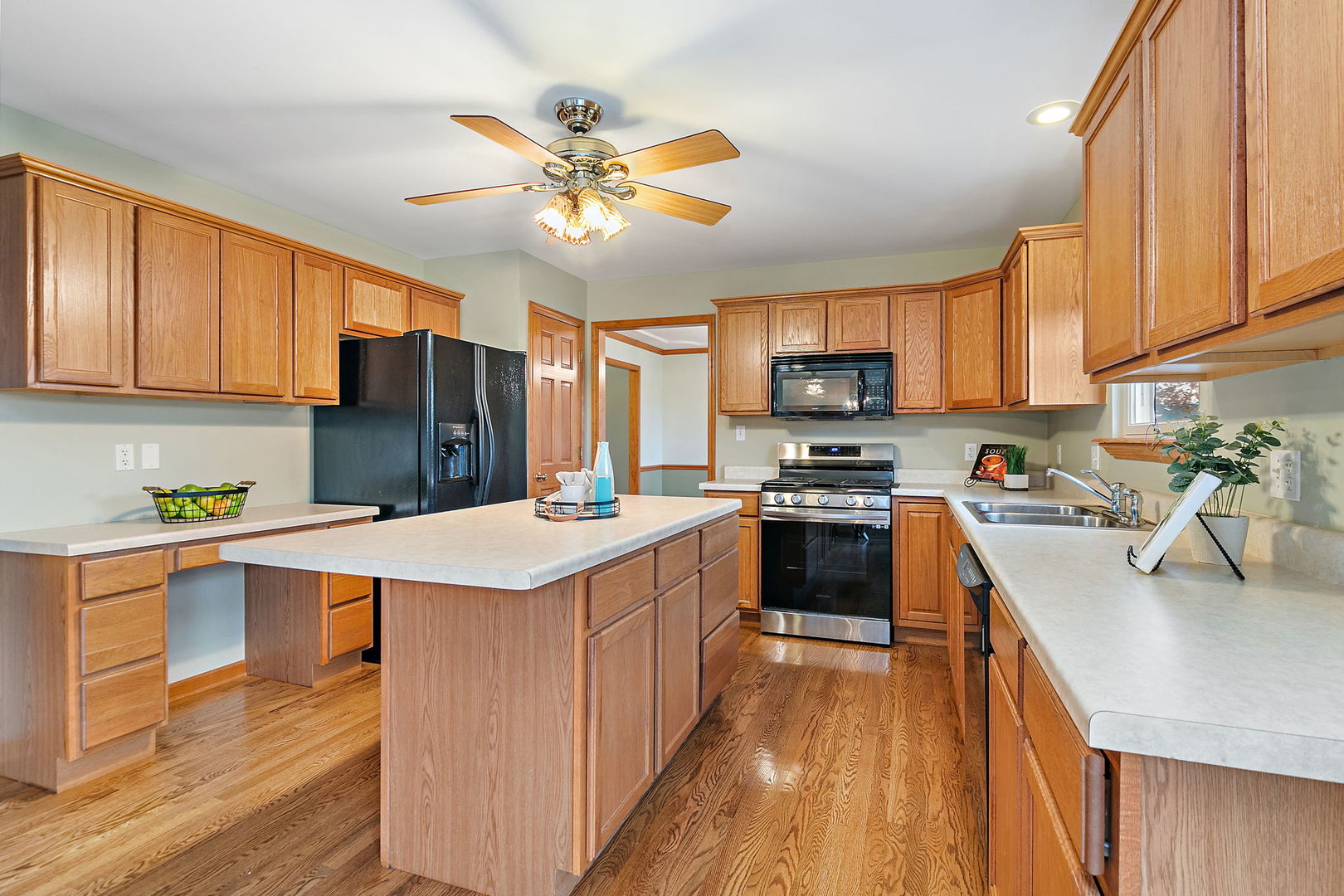 685 Persimmon Street DeKalb, IL 60115 - Photo 10 of 38 a kitchen with stainless steel appliances a stove top oven a sink dishwasher and a refrigerator