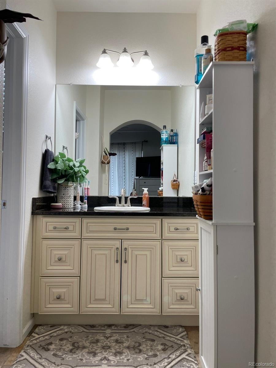12948 Grant Circle East, Unit B Thornton, CO 80241 - Photo 15 of 24 a bathroom with a sink and a mirror