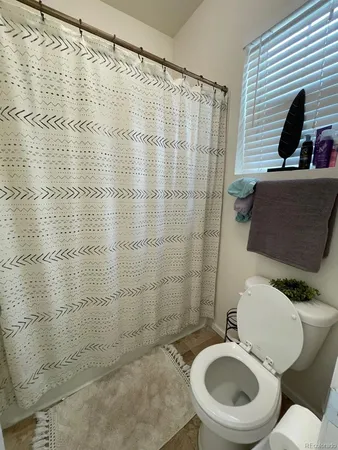 a spacious bedroom with a bed and a window