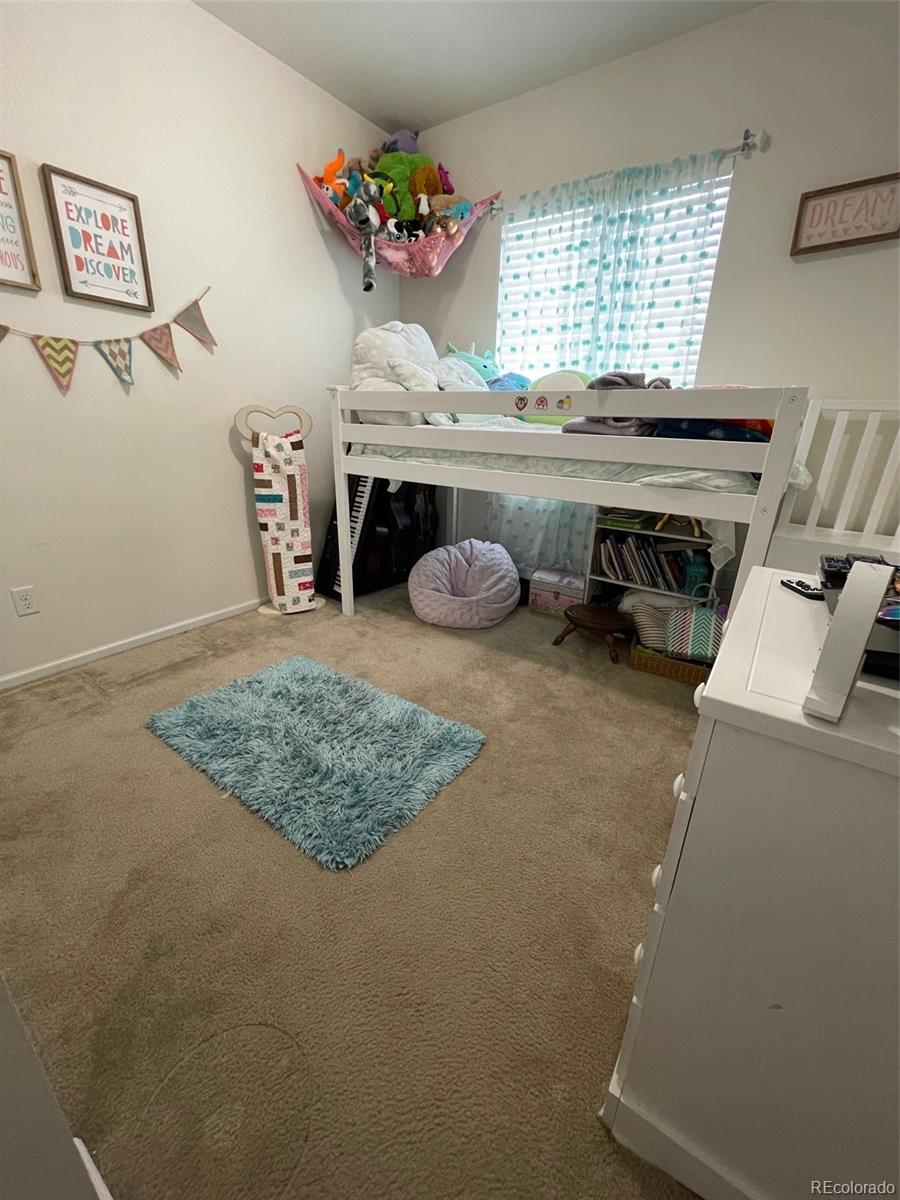 12948 Grant Circle East, Unit B Thornton, CO 80241 - Photo 18 of 24 a room with furniture and window