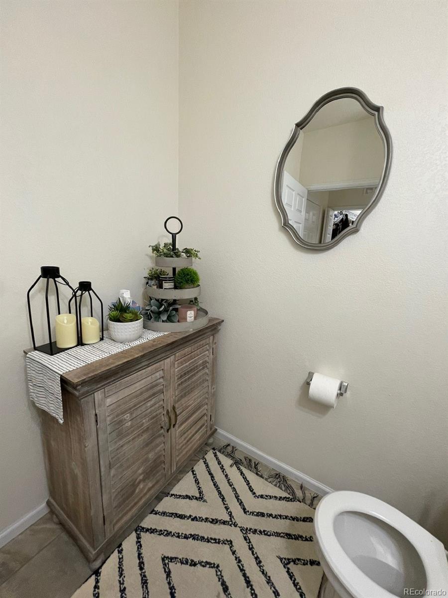 12948 Grant Circle East, Unit B Thornton, CO 80241 - Photo 20 of 24 a bathroom with a sink mirror and vanity
