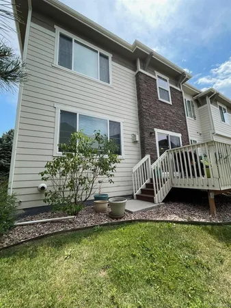 a view of a patio with table and chairs potted plants with wooden floor