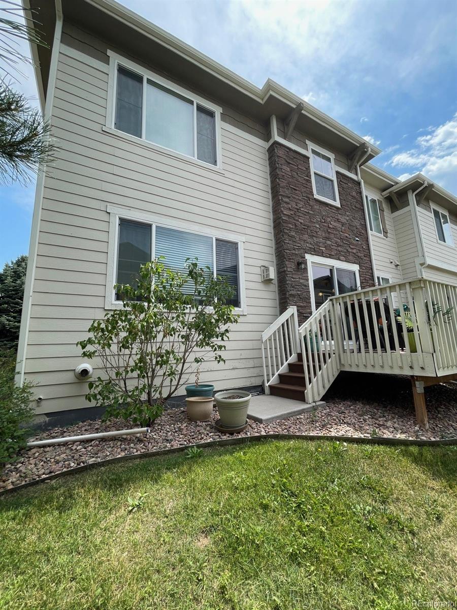 12948 Grant Circle East, Unit B Thornton, CO 80241 - Photo 23 of 24 a front view of a house with a garden