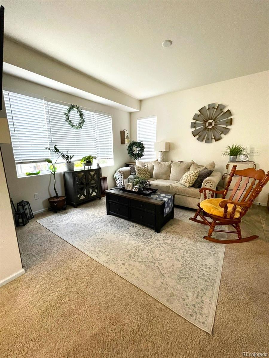 12948 Grant Circle East, Unit B Thornton, CO 80241 - Photo 4 of 24 a living room with furniture rug and window