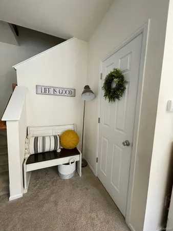 a living room with furniture a chandelier and a dining table