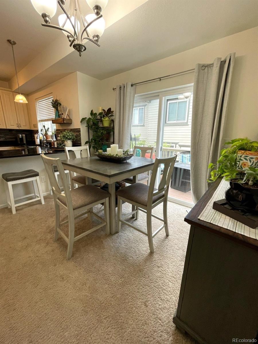 12948 Grant Circle East, Unit B Thornton, CO 80241 - Photo 7 of 24 a view of a dining room with furniture window and wooden floor
