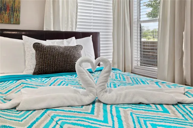 a bedroom with a bed and a window