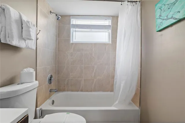 a bathroom with a bathtub and a toilet