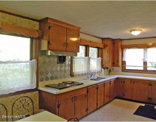 11 Burrington Road Charlemont, MA 01339 - Photo 2 of 11 a kitchen with a stove a sink and a refrigerator