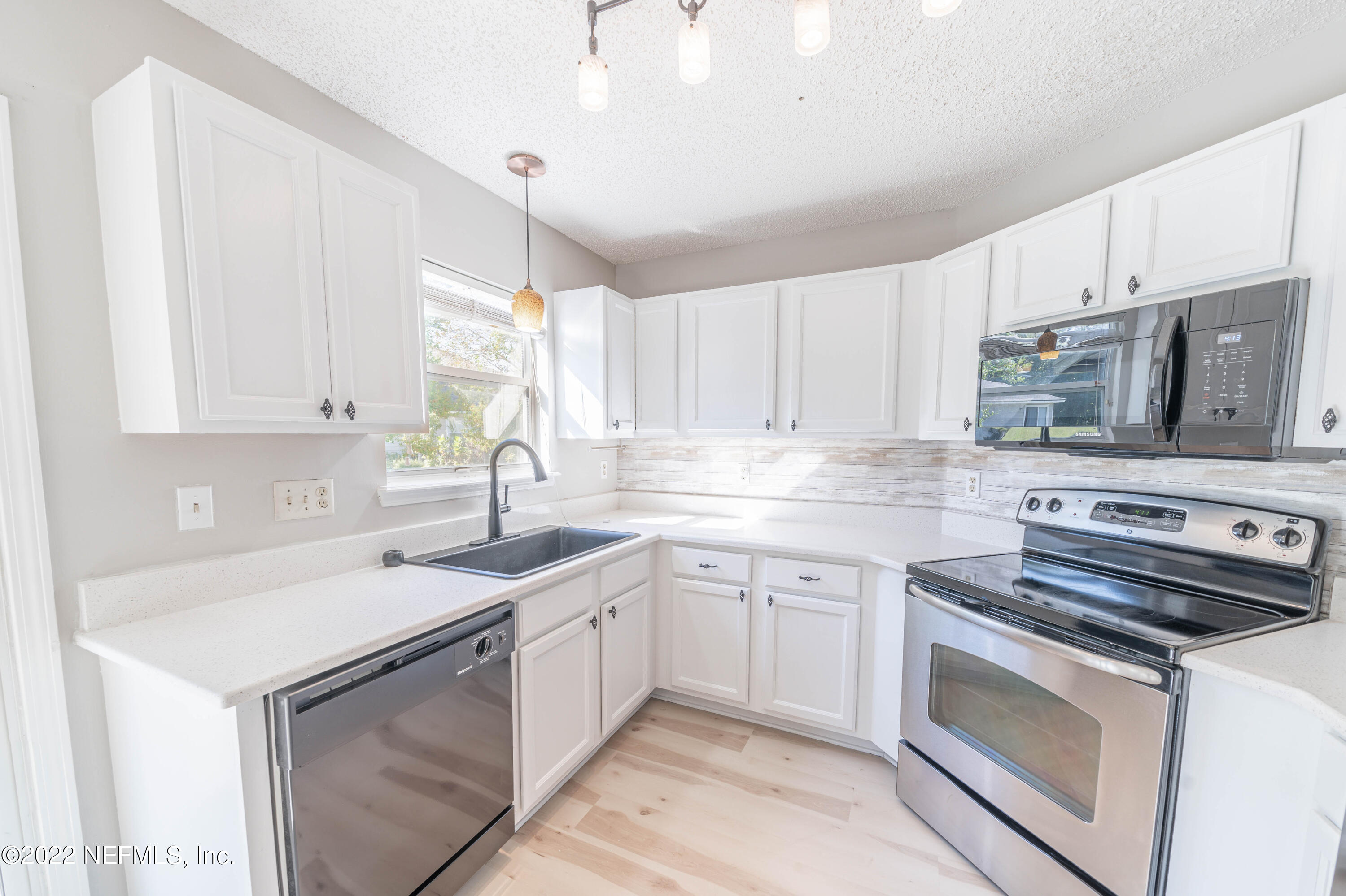 500 South Steel Bridge Road, Unit 3 St. Johns, FL 32259 - Photo 12 of 43 a kitchen with appliances cabinets and a sink