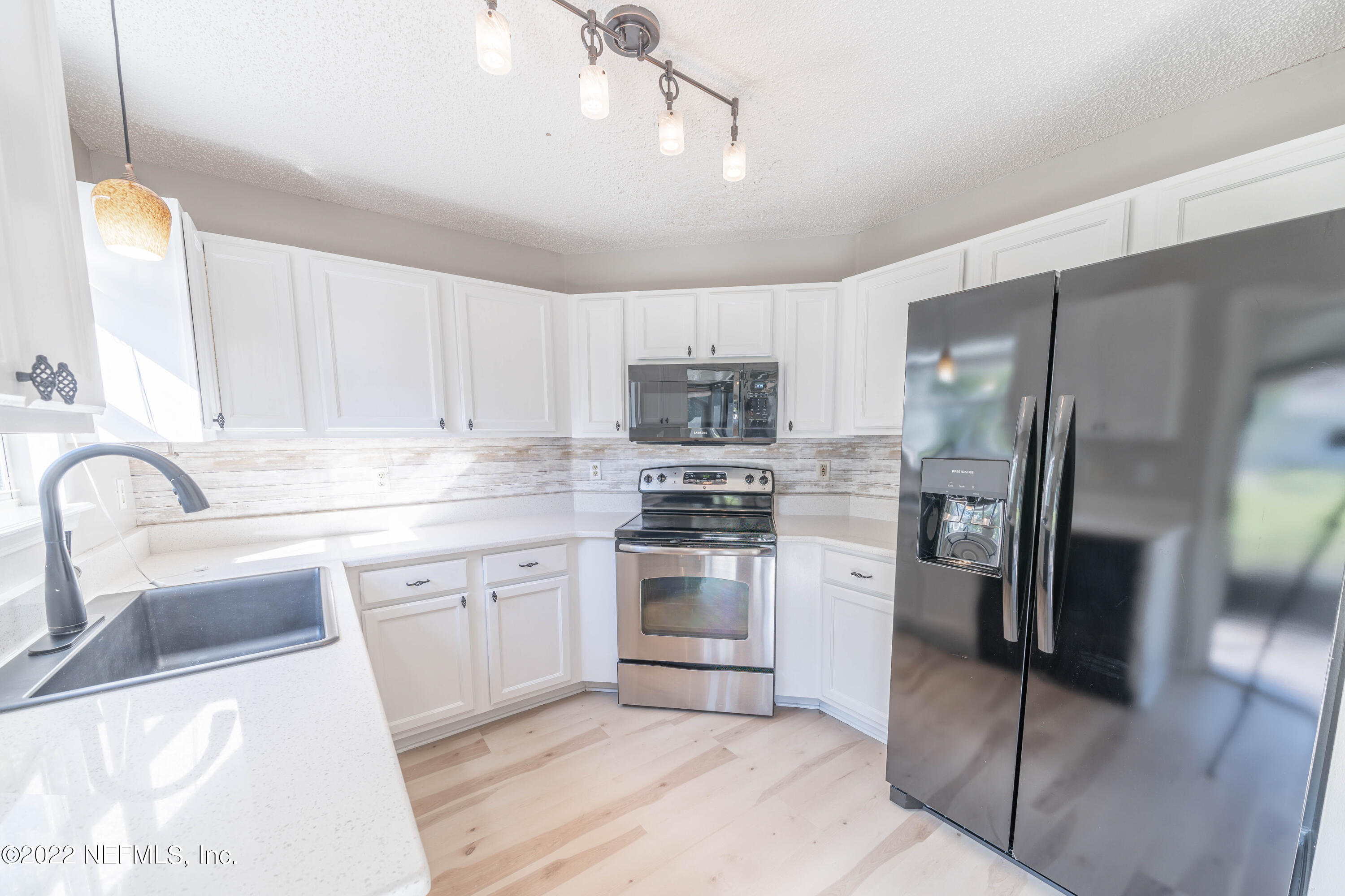 500 South Steel Bridge Road, Unit 3 St. Johns, FL 32259 - Photo 13 of 43 a kitchen with a sink stainless steel appliances and cabinets