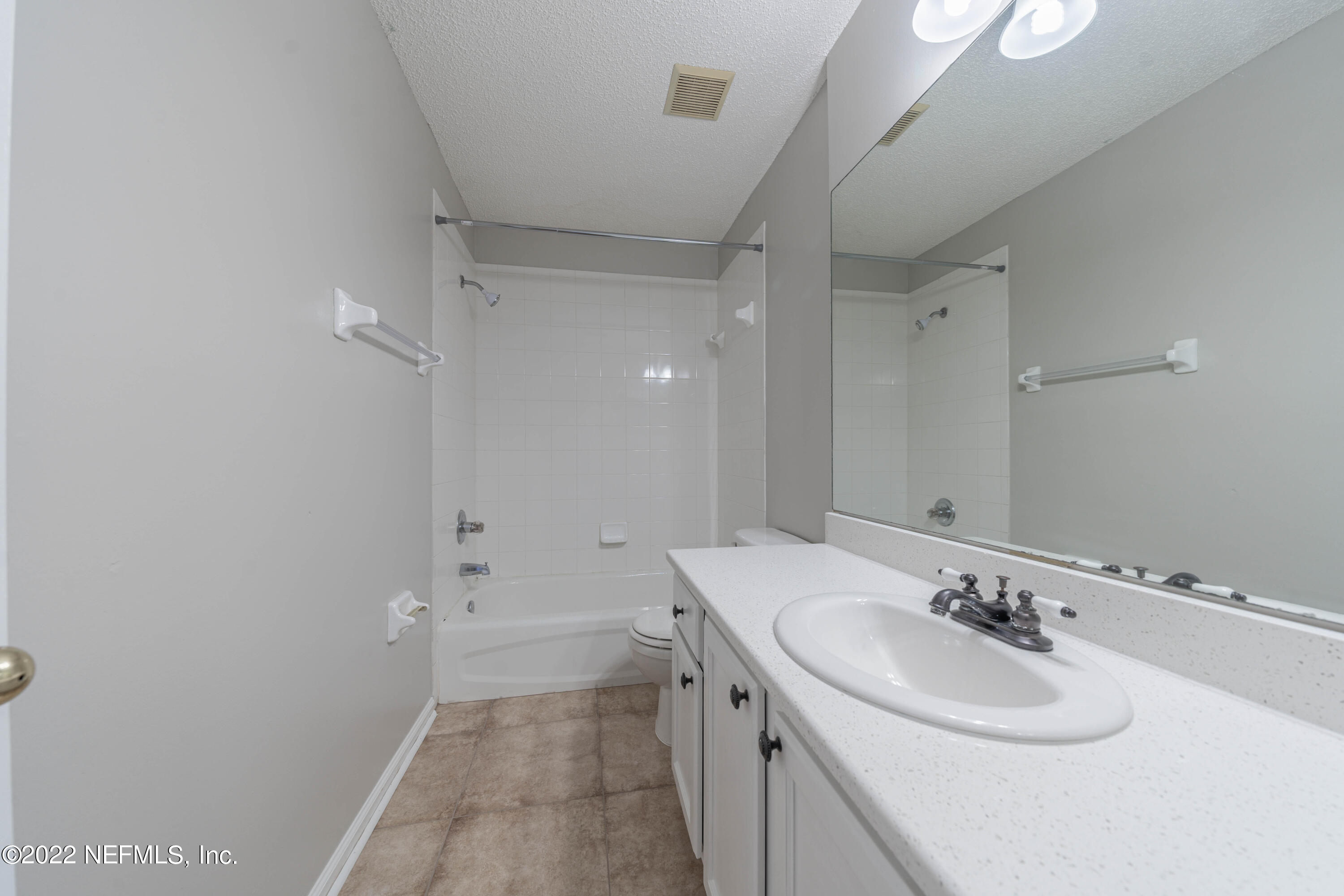 500 South Steel Bridge Road, Unit 3 St. Johns, FL 32259 - Photo 23 of 43 a bathroom with a sink a toilet and a mirror
