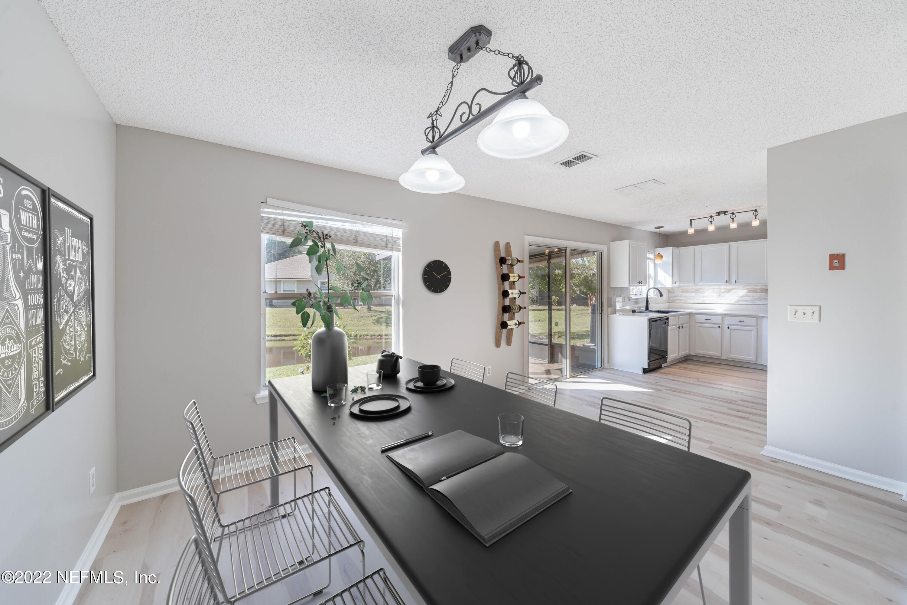 500 South Steel Bridge Road, Unit 3 St. Johns, FL 32259 - Photo 36 of 43 a view of a dining room with furniture wooden floor and a chandelier