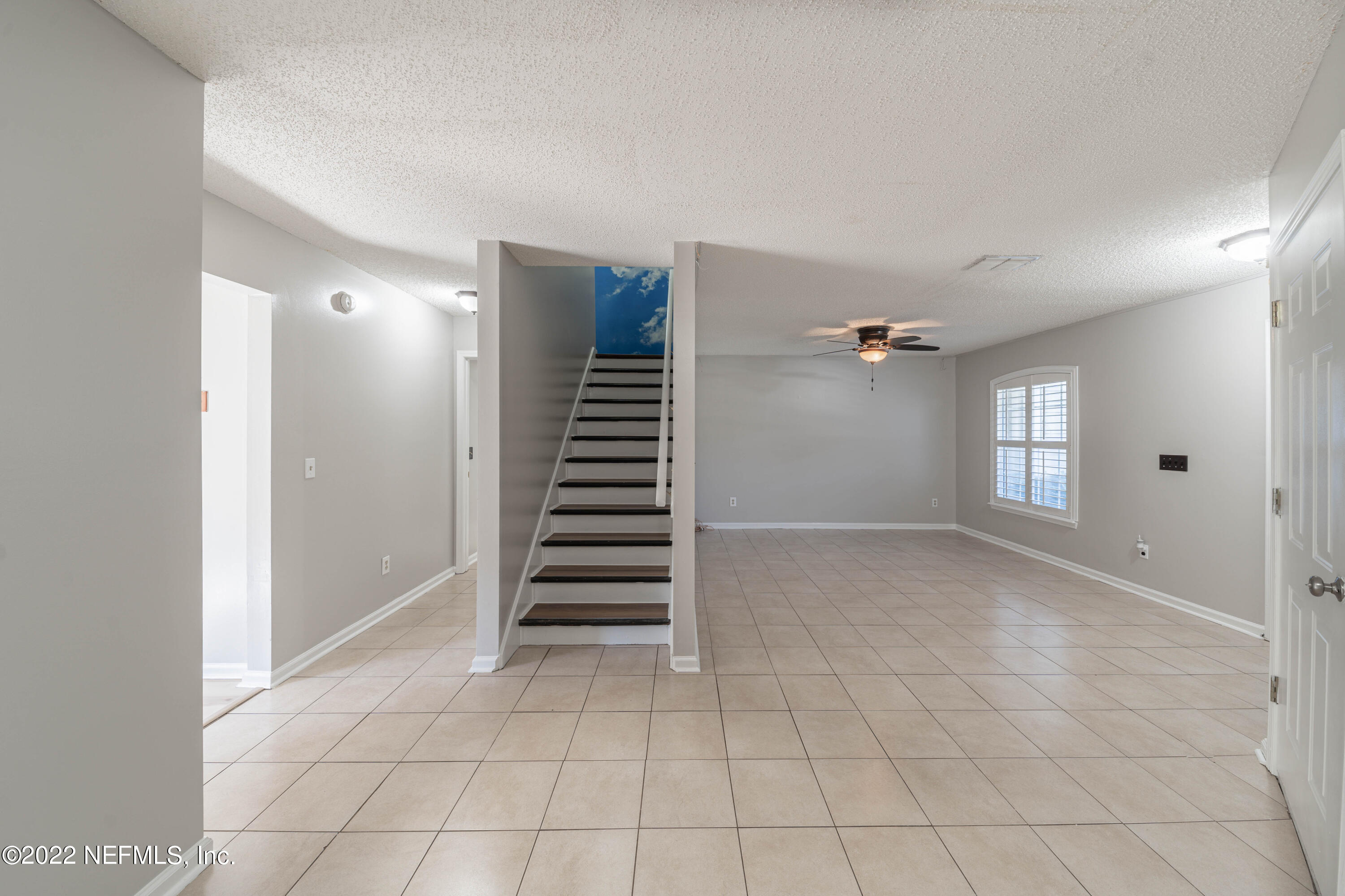 500 South Steel Bridge Road, Unit 3 St. Johns, FL 32259 - Photo 8 of 43 a view of an empty room with stairs and a window