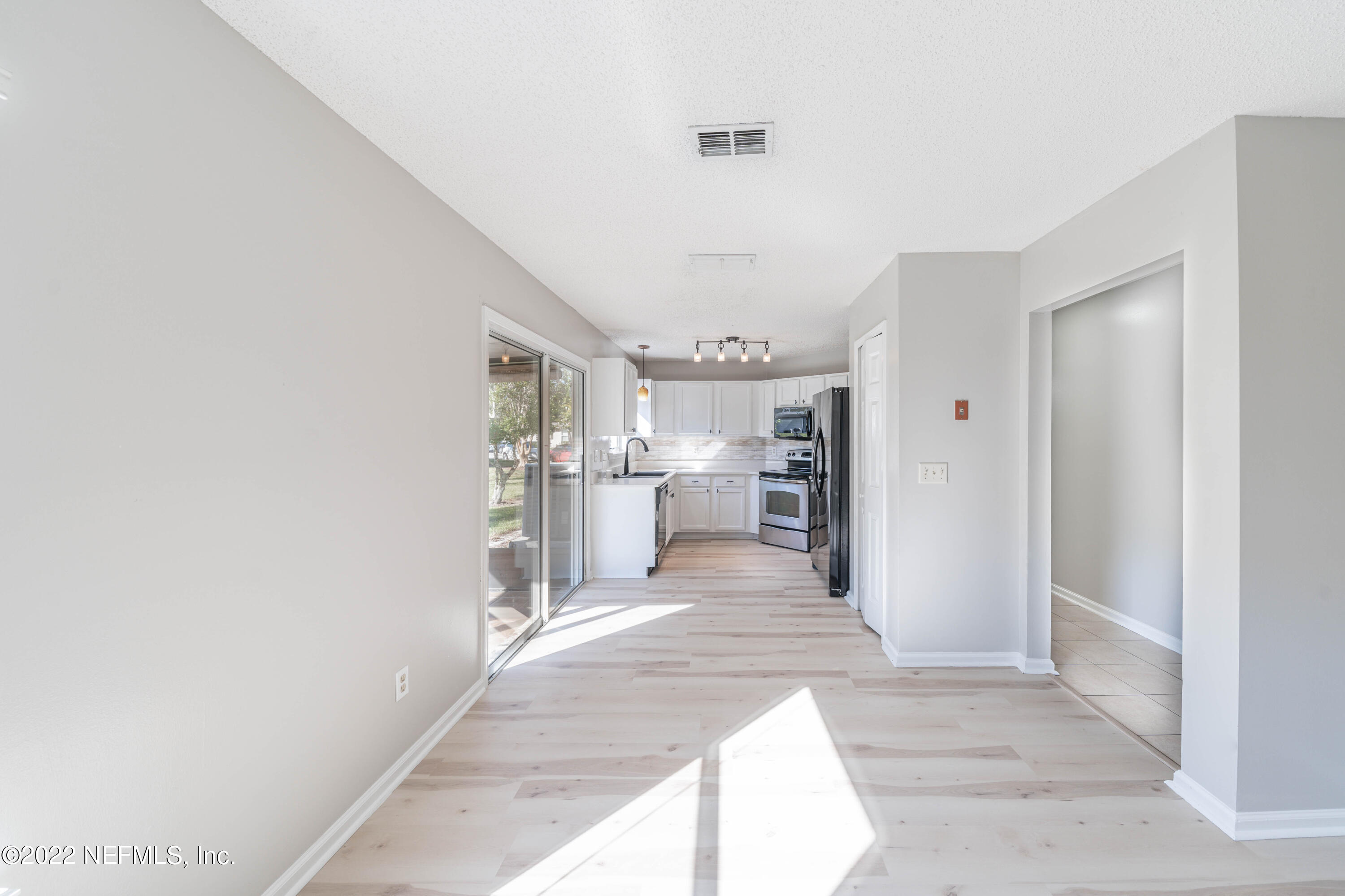 500 South Steel Bridge Road, Unit 3 St. Johns, FL 32259 - Photo 10 of 43 a view of a kitchen with kitchen island cabinets and refrigerator