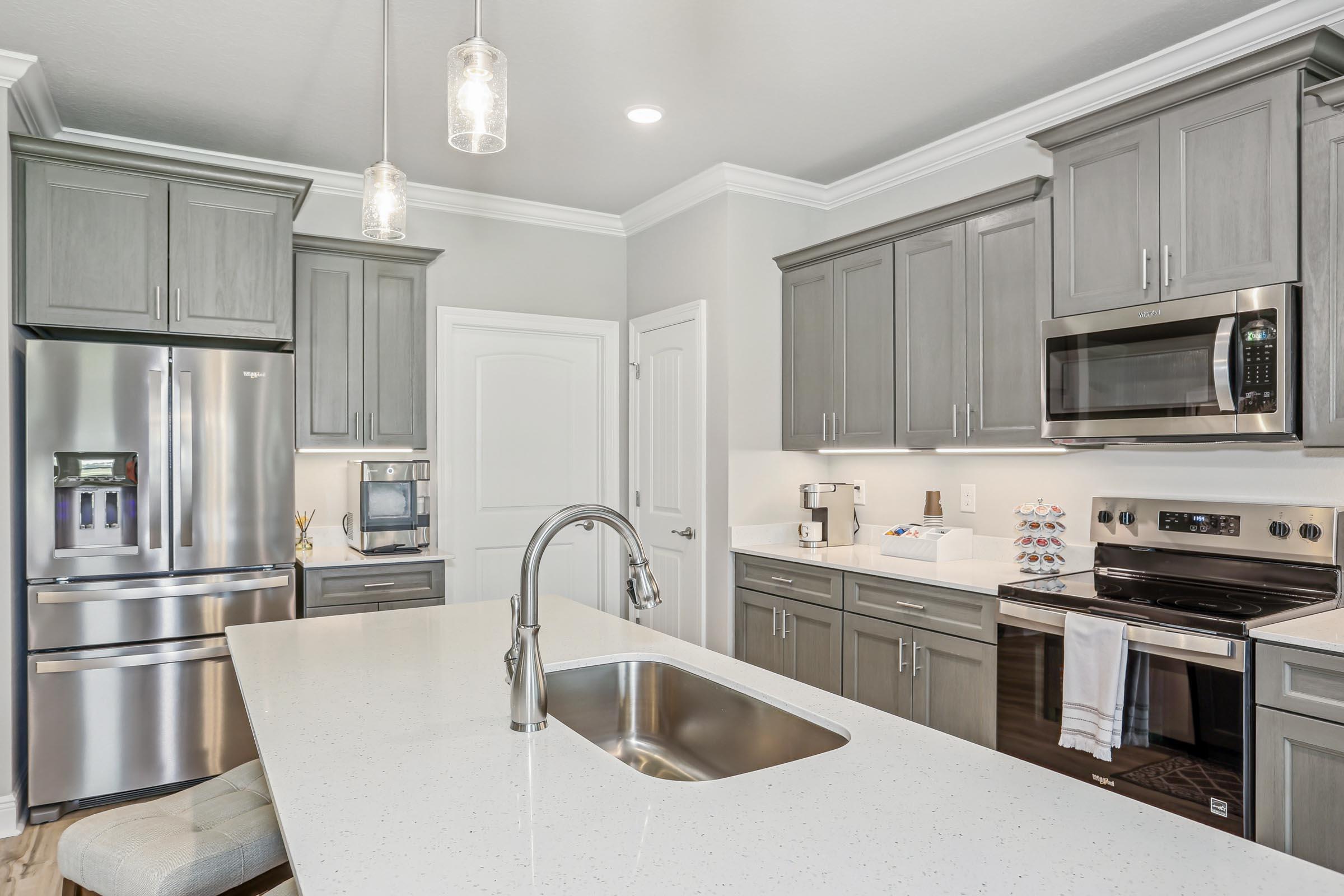 4863 Horace Lunsford Road Milton, FL 32570 - Photo 11 of 36 a kitchen with stainless steel appliances a stove a sink a microwave and cabinets